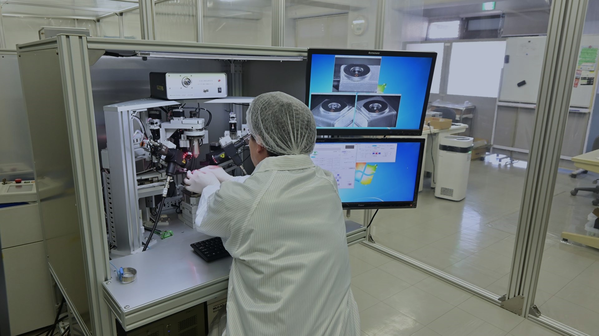 Workers handling precision machinery in a clean room